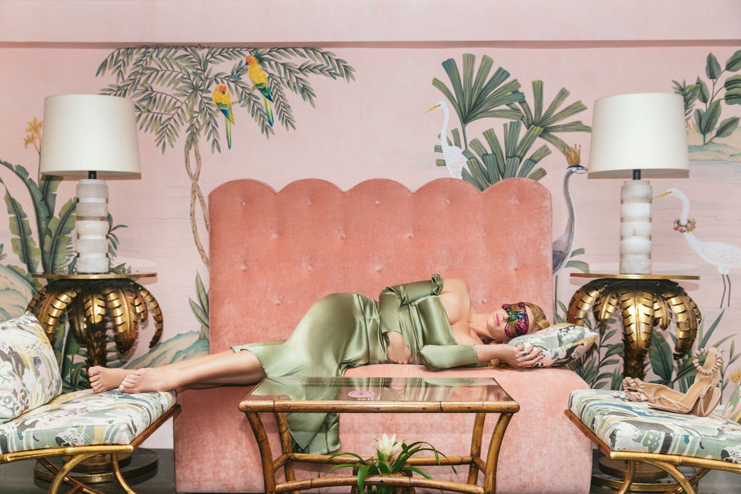 sleeping beauty, the colony hotel, palm beach, palm beach design, palm beach interiors, palm beach hotel, pink sofa, pink velvet sofa, de gournay wallpaper, pink wallpaper, bird wallpaper, lady sleeping, model sleeping, eye cover, green silk dress,