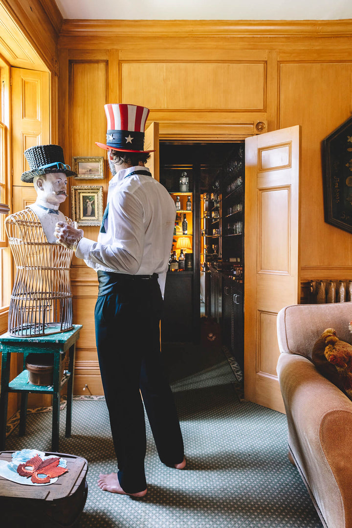 A man in an old fashion room dressed for the 4th of July