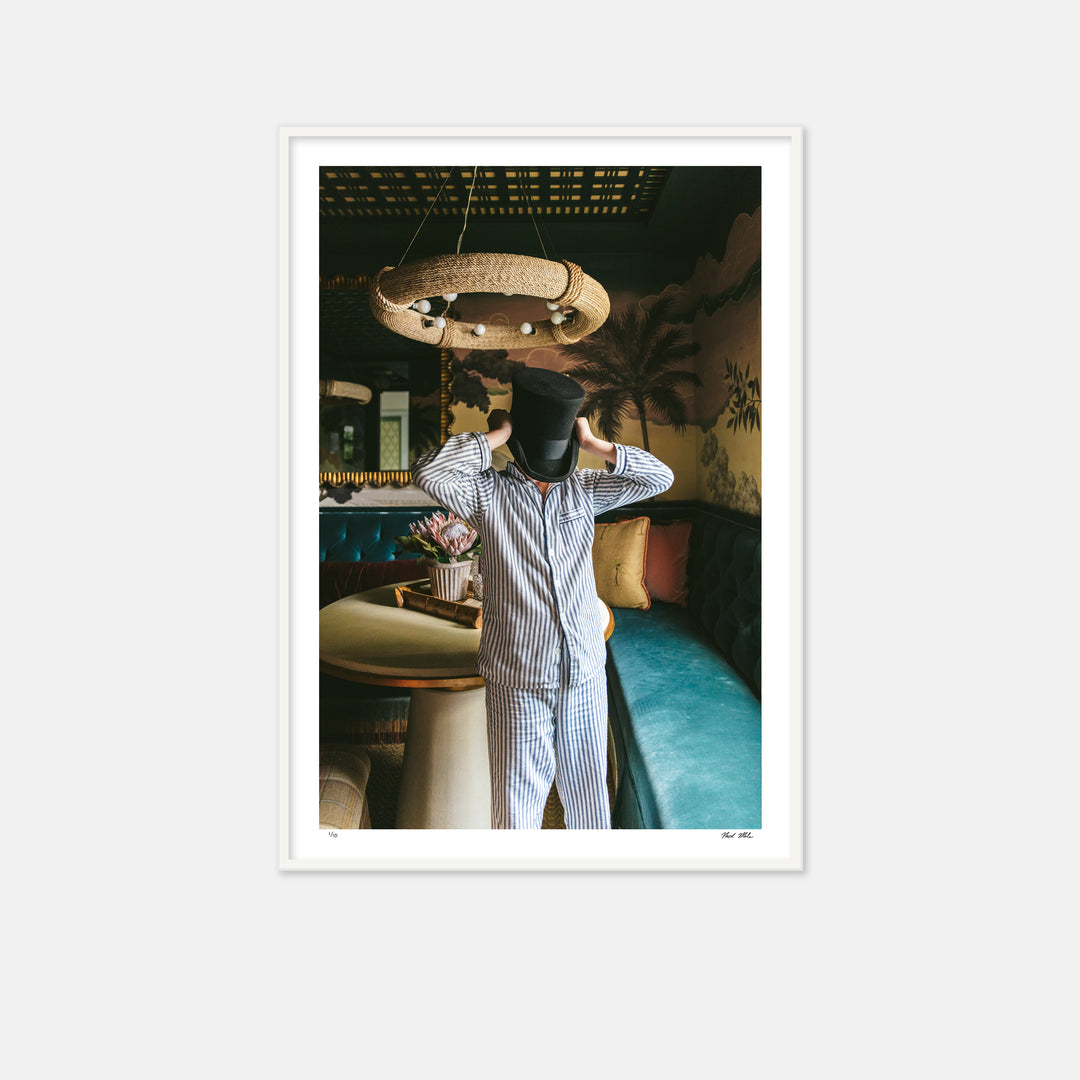 boy in bar room wearing pajamas and a top hat