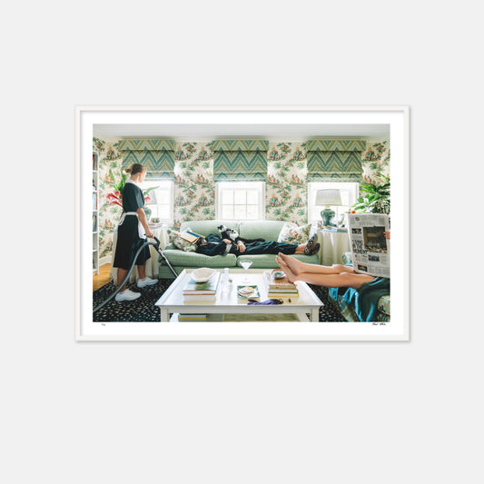 living room with lemur on green sofa with maid and lady reading the paper