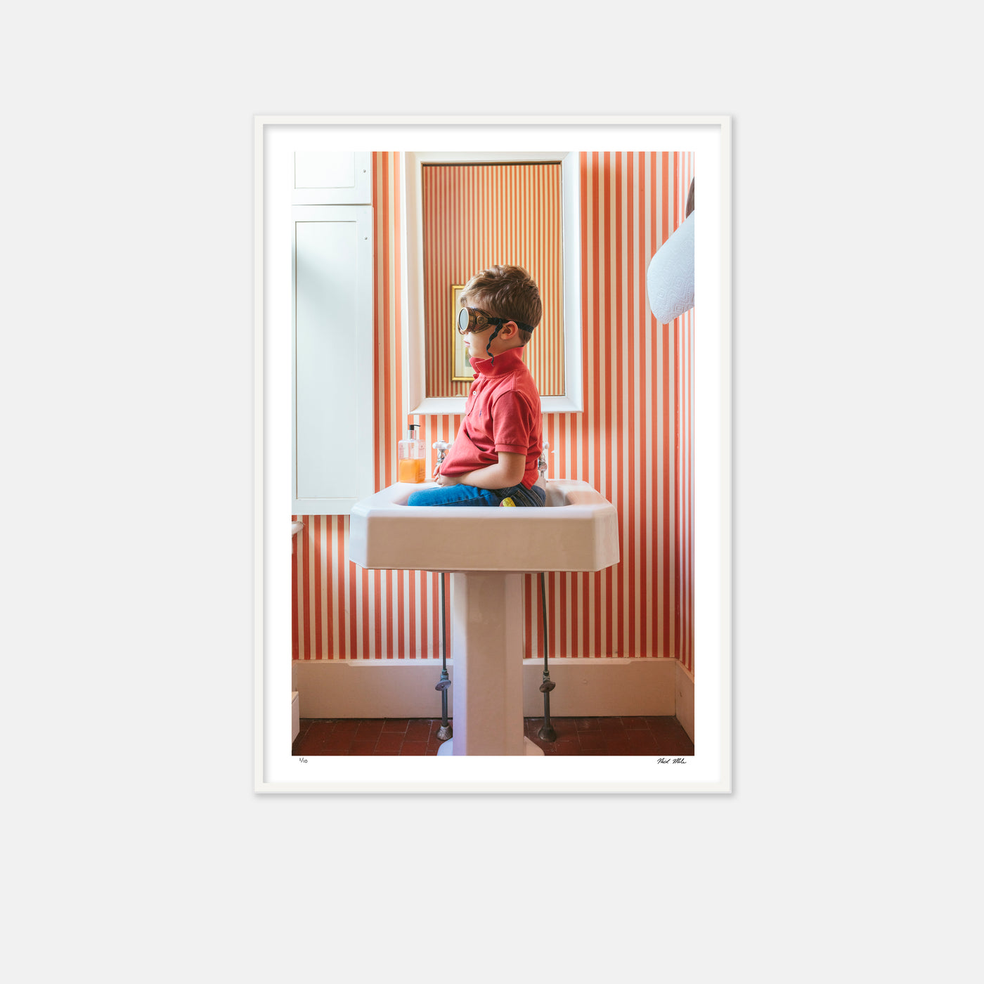 framed boy in sink with goggles and red and white striped wallpaper