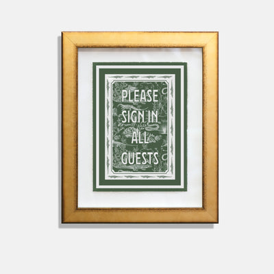 alligator print with green background with text saying "please sign in all guests" in a gold frame.