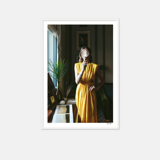 Woman in a yellow dress holding magify glass. Palm frond, palm beach, palm beach decor, palm beach style