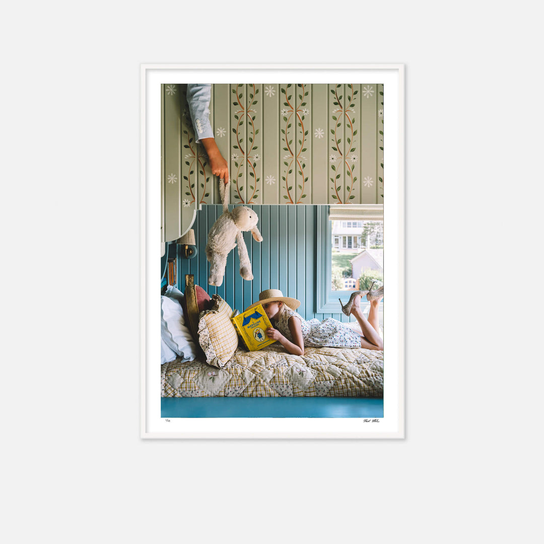 A little girl reading on bottom of bunkbed. A little boy is on the ned above trying to distract her with a teddy bear