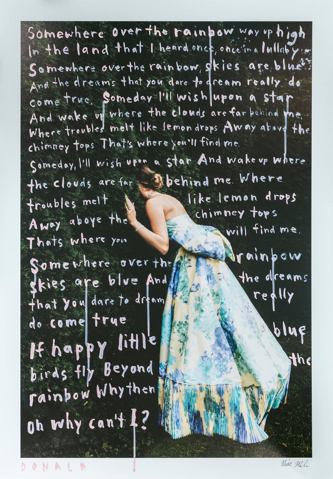 Woman in a floral dress standing in front of a blackboard with text, with a white border.