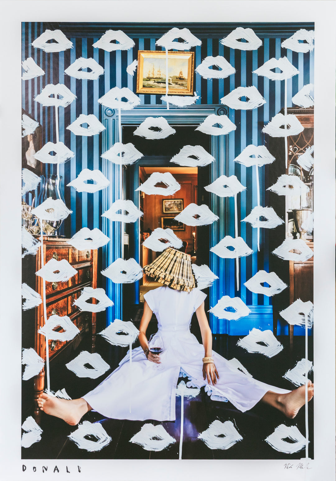 Woman in a white dress sitting on the floor with white masks around her, in a room with blue walls and a mirror.