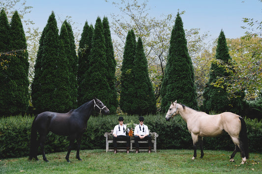 two men in hats with horses