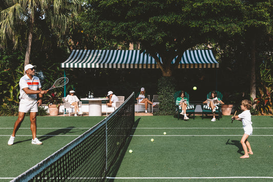 group of people watching tennis lesson