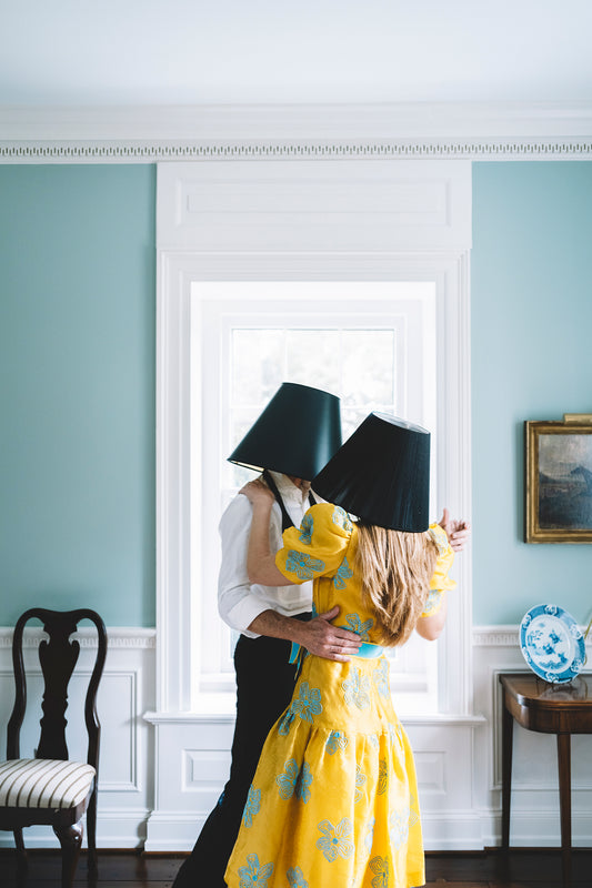 man and woman dancing with lamp shades