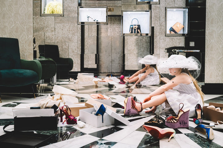 Girl in a veiled hat tries on platform heels among scattered shoe boxes. Nick Mele x Bergdorf Goodman, A New York Affair
