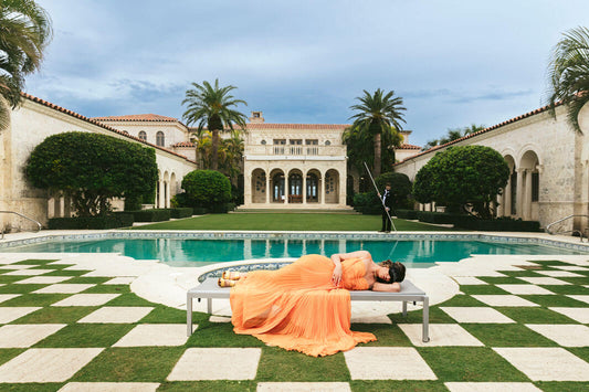 sleeping beauty, palm beach, palm beach architecture, pool design, eye mask, sleeping mask, orange dress, checkerboard patio, checkerboard pool deck, spanish style architecture, gilded age, la follia, palm beach estate